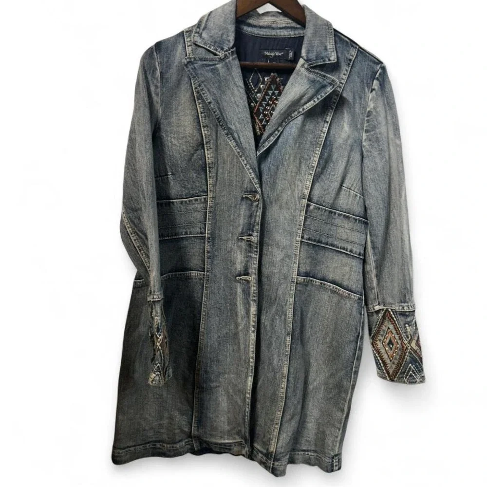 Blue denim jacket with embroidered sleeves,‎ featuring a boho western vibe
